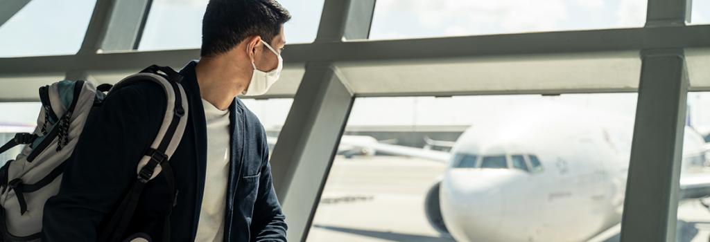 Man looking at plane in airport