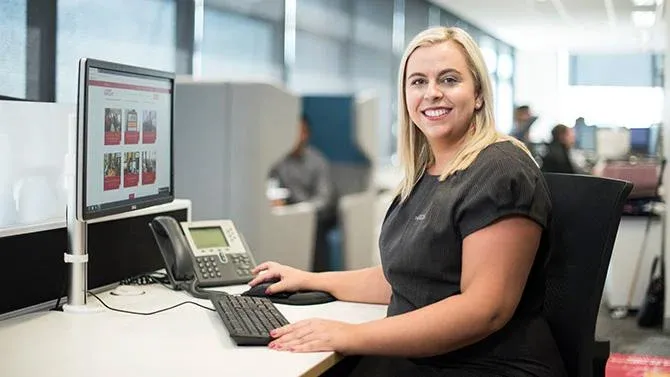 Business travel consultant sitting at a desk