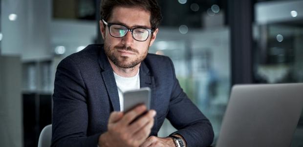 Business man looking at phone.