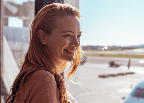 woman looking out airport window