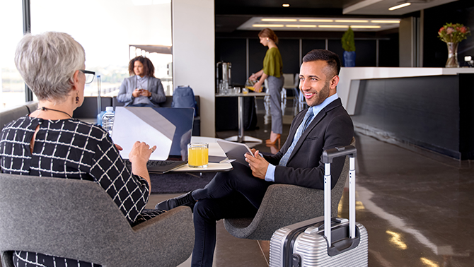 Two people into sitting in an airport lounge