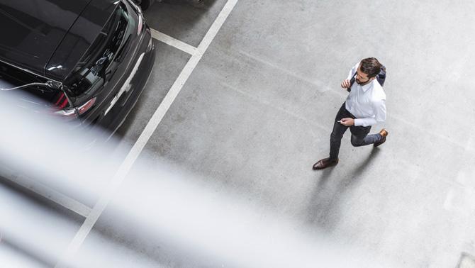 Man walking in a parking lot